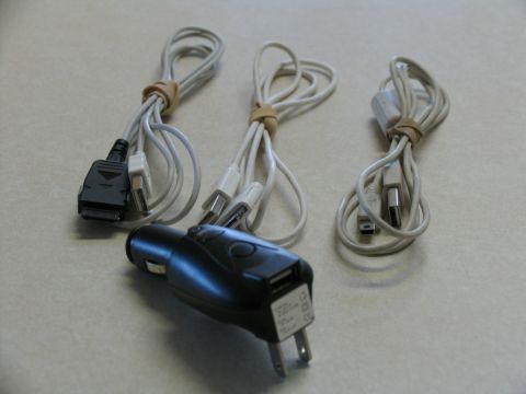 1984 Ford Bronco - A car charger with multiple USB ports is shown alongside three bundled charging cables, likely for various electronic devices.