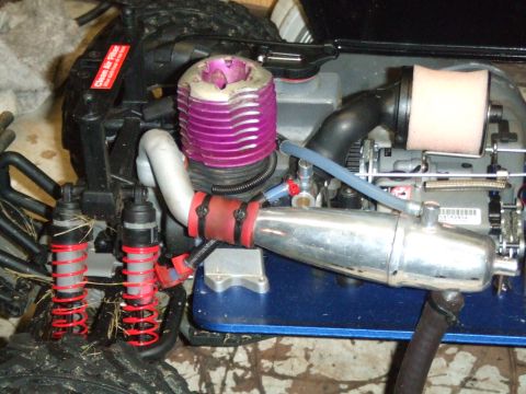 1996 Ford Bronco - Close-up of a toy RC car engine, showing its exhaust and air filter components.