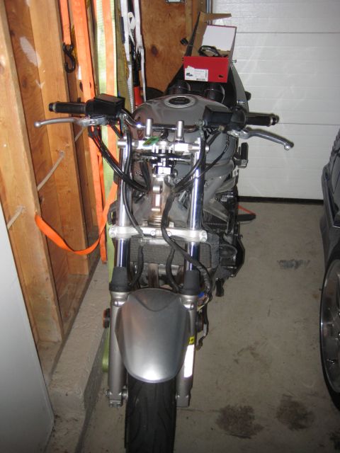 2003 Suzuki Bandit S - A motorcycle is parked in a garage, showing its front wheel, suspension, and handlebars.