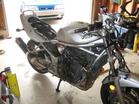 2003 Suzuki Bandit S - Silver Suzuki motorcycle, possibly a Bandit S, undergoing work in a garage setting.