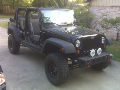 2008 Jeep Wrangler - Black Jeep Wrangler with doors removed, showing its interior and exterior.