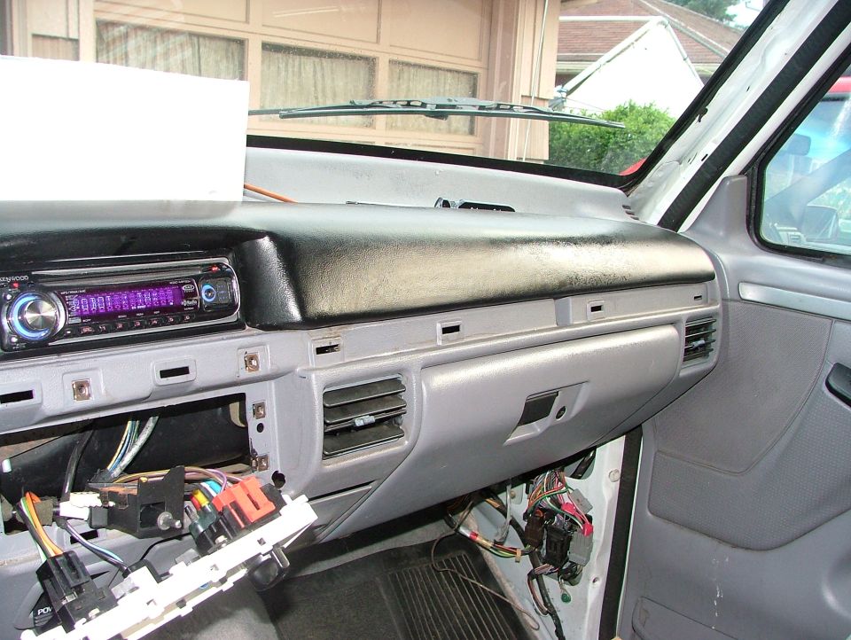 Ford pickup dash torn down with exposed wiring and an aftermarket Kenwood CD stereo installed