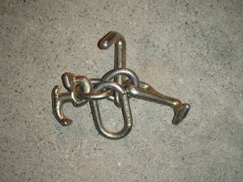 1995 Ford Bronco - Metal tow hooks and chain assembly on concrete.