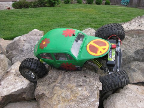 2010 Ford Pickup - A remote-controlled car with a custom paint job navigates a rocky terrain.