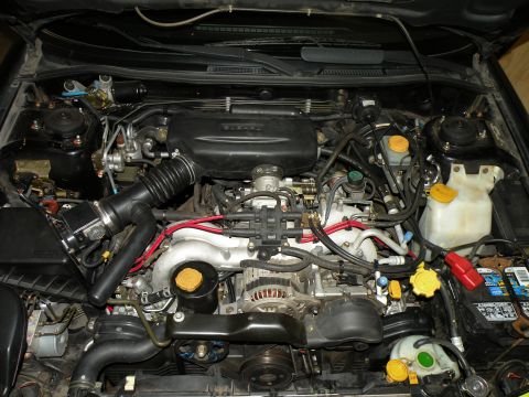 1998 Subaru Legacy - Engine bay of a 1998 Subaru Legacy, showing the engine components and wiring.