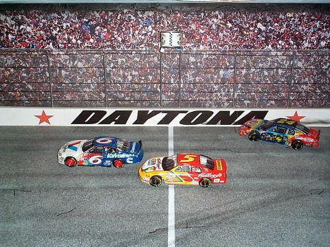 1971 Ford Ranchero - Toy cars with sponsor decals are on a race track, with a checkered flag finish line marker.
