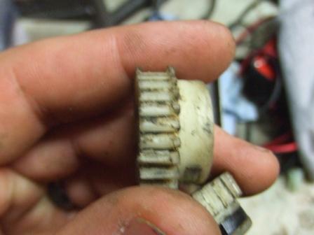 1996 Ford Bronco - A close-up shows a worn plastic gear held between fingers, with a watermark at the bottom.