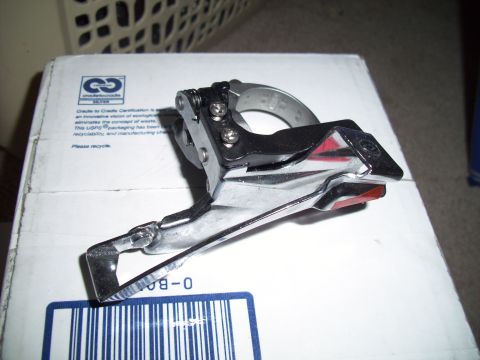 1993 Ford Probe - A close-up view of a bicycle front derailleur resting on a white cardboard box with shipping labels.