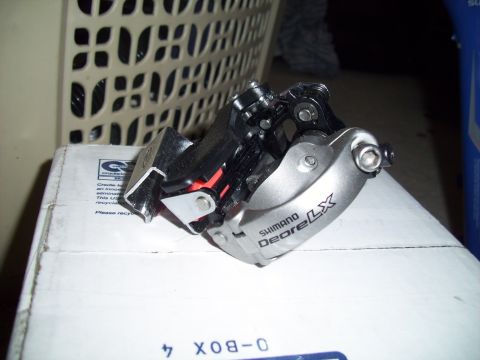 1993 Ford Probe - A bicycle derailleur with 'Shimano Deore LX' text is shown on a white cardboard box.