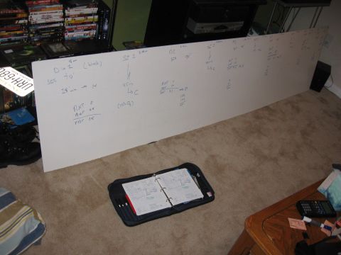 2001 Ford F-150 - A whiteboard covered in handwritten notes and diagrams is displayed on the floor.