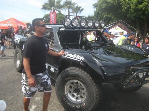 1996 Ford Bronco - Man poses with a custom off-road truck, possibly modified for desert racing.