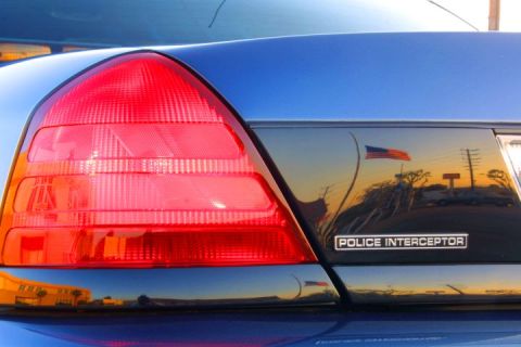 1998 Ford Crown Victoria - Rear detail of a 1998 Ford Crown Victoria Police Interceptor, showing the taillight and a reflection.