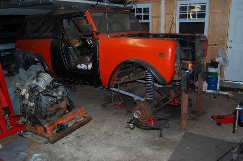 1994 Ford Bronco - Disassembled International Scout II in a garage, undergoing repairs with engine out of the vehicle.