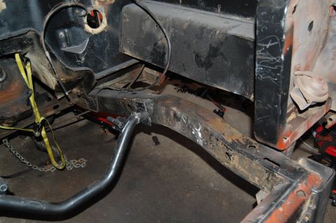 1994 Ford Bronco - Close-up view of a vehicle's undercarriage, revealing frame damage and repair work.