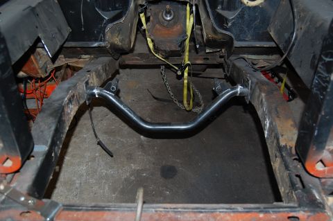 1994 Ford Bronco - The underside of a vehicle is shown, revealing the frame, transmission, and suspension components.
