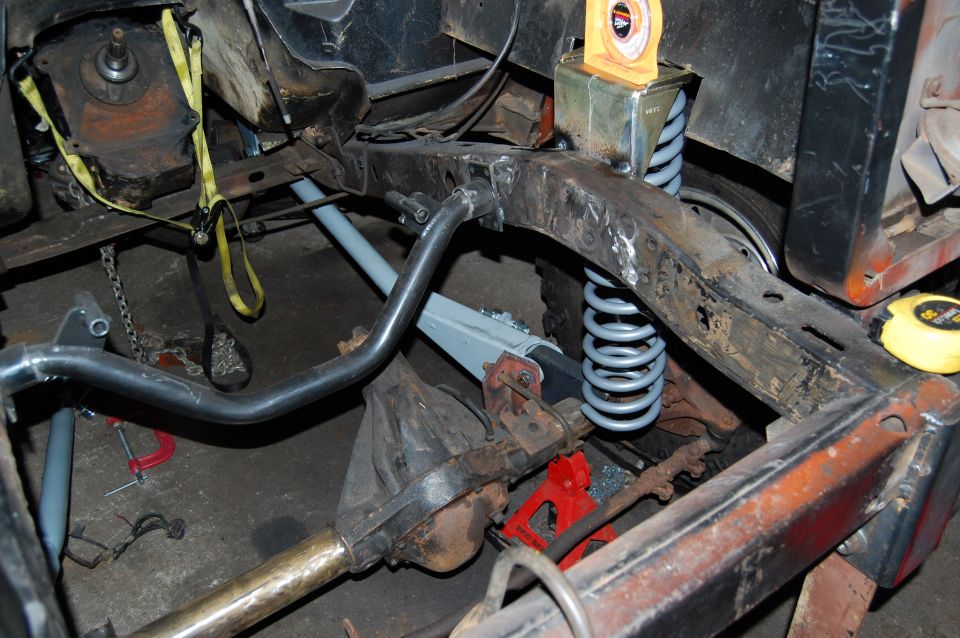 Vehicle frame with suspension, differential, and exhaust components visible