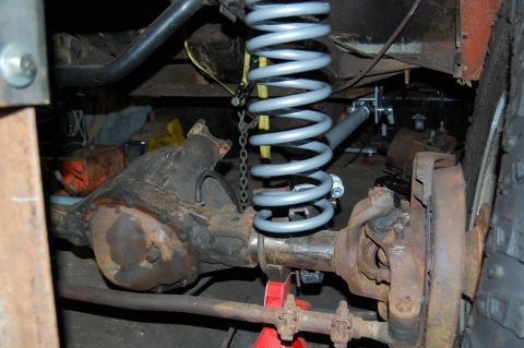 1994 Ford Bronco - This is a close-up view of a vehicle's suspension system, showing the differential and a new coil spring.