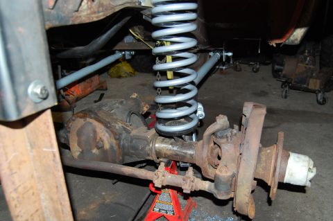 1994 Ford Bronco - Vehicle suspension components, including axle and coil spring, are shown in detail.