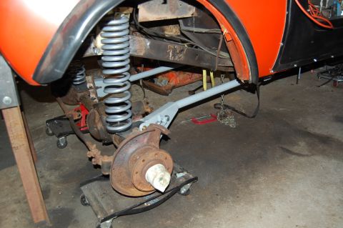 1994 Ford Bronco - The vehicle's front suspension is disassembled for repair, showing new springs and rusty components.