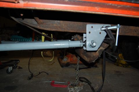 1994 Ford Bronco - Close-up of a custom bracket and rod assembly installed on the underbody of a vehicle.