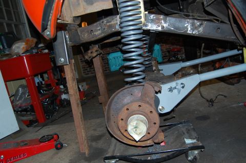 1994 Ford Bronco - The vehicle is on jack stands in a garage, undergoing suspension work.