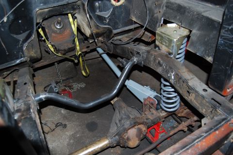 1994 Ford Bronco - Close-up view of a vehicle's undercarriage, showing the frame, suspension, and drivetrain components.