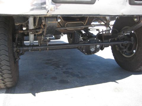 1996 Ford Bronco - Close-up of the rear axle and suspension components of a vehicle.