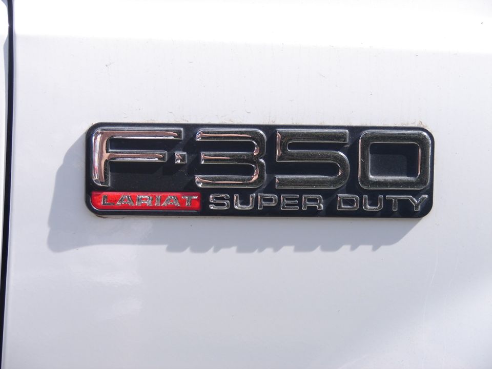 F-350 Lariat Super Duty emblem on white vehicle body