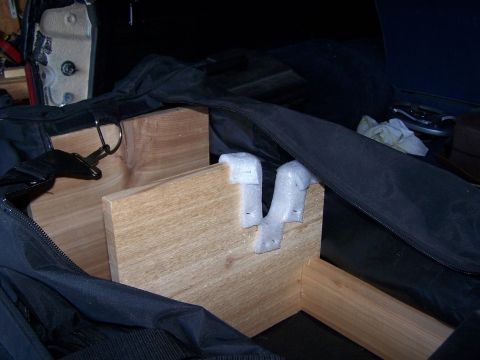 1986 Ford Bronco - A custom wooden structure with foam padding is secured inside a large black bag.