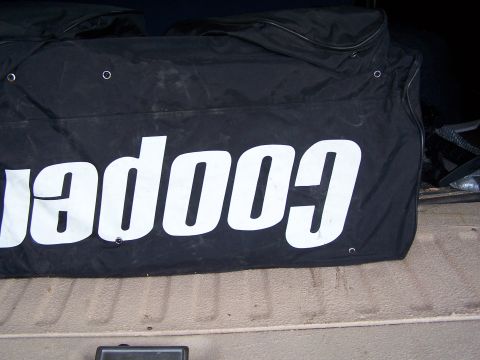 1986 Ford Bronco - A black bag with 'cooper' in large white letters is shown, possibly in the cargo area of a vehicle.