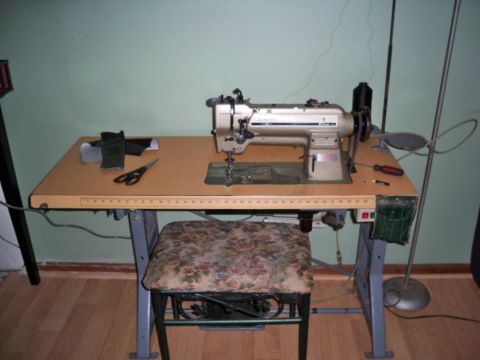 1995 Ford Probe - A sewing machine is set up on a table, with various sewing tools and a floor lamp nearby.