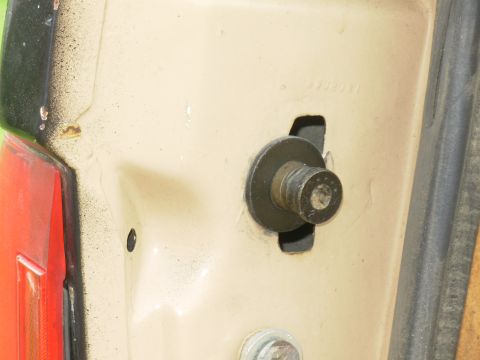 1983 Ford Bronco - This is an '83-96 tailgate strike bolt installed in the hole for a '78-82 type using a large angle-iron nut plate (not visible inside). Alt…