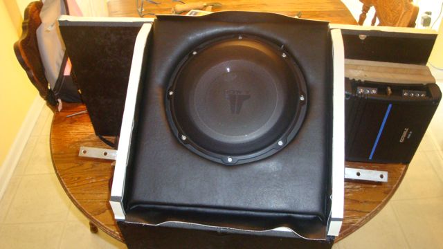 JL Audio subwoofer in a black vinyl-wrapped box on a table