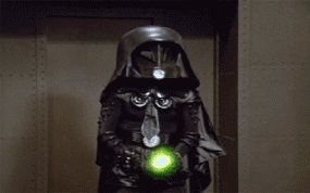 2006 Ford E350 - A person in a dark, elaborate costume holds a bright green orb.