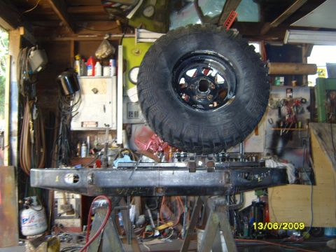 1989 Ford Bronco - A custom off-road bumper and spare tire are shown in a workshop setting.