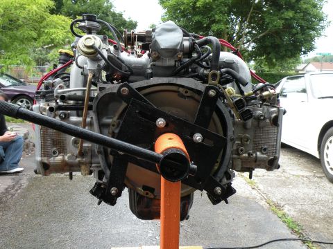 1998 Subaru Legacy - A Subaru EJ22 engine is mounted on an engine stand, ready for work or installation.