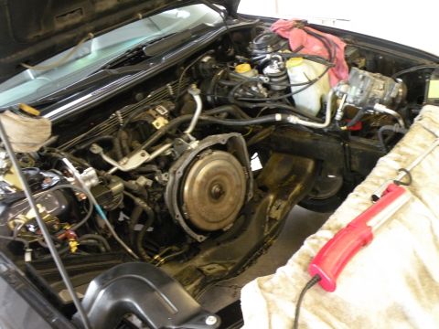 1998 Subaru Legacy - Engine bay with transmission removed, work light nearby.