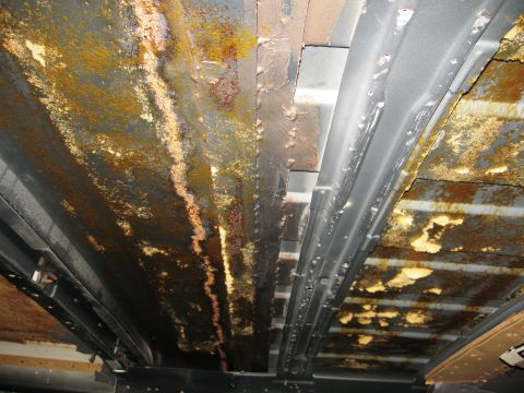 1986 Ford Bronco - Extensive rust damage is visible on the undercarriage of this vehicle, indicating significant corrosion.