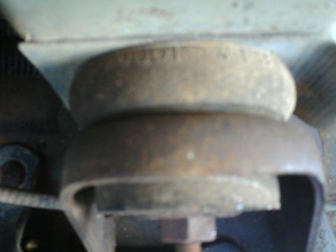 1990 Ford Bronco - This is a close-up view of a rusty engine mount assembly.