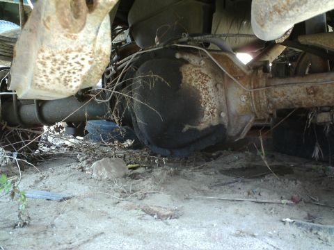 1990 Ford Bronco - Undercarriage view of a vehicle's rear axle, showing signs of wear and neglect.