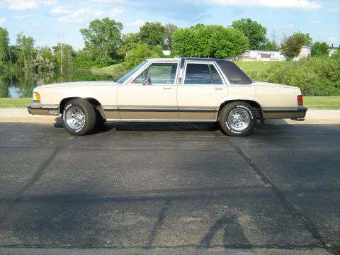 1988 Mercury Grand Marquis - This 1988 Mercury Grand Marquis is seen from the side, a two-tone paint scheme and chrome wheels.