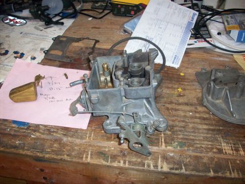 1978 Jeep CJ5 - A disassembled carburetor sits on a workbench next to a Sears receipt and a note with dates.