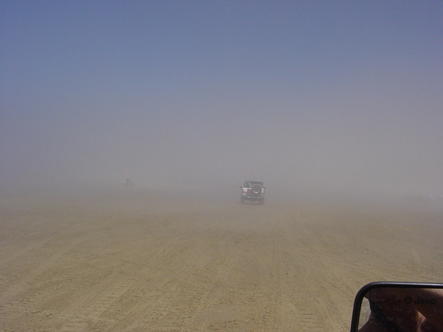 1995 Jeep Wrangler driving in a dust storm, rear view