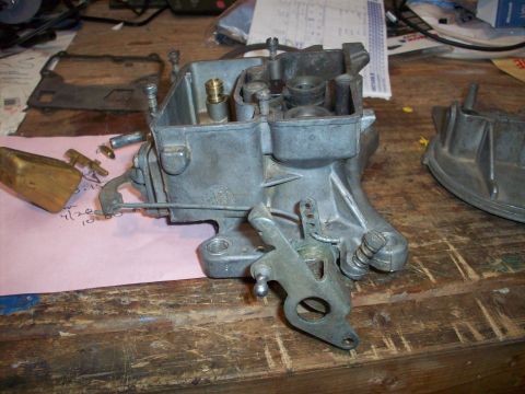 1978 Jeep CJ5 - Holley carburetor disassembled on a workbench, with parts and paperwork nearby.
