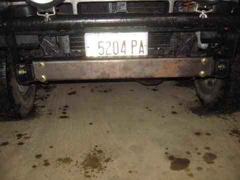 1993 Ford Bronco - A vehicle's front end is shown, a custom metal bumper and tires.