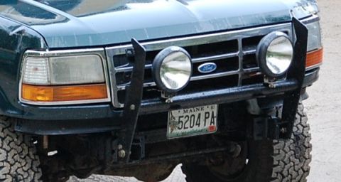 1993 Ford Bronco - Front view of a 1993 Ford Bronco showing its grille, headlights, and custom bumper with lights.