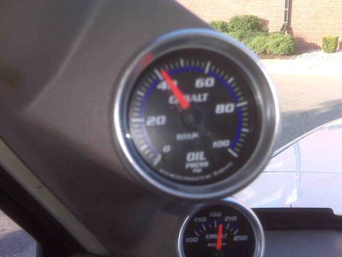 1995 Ford Bronco - Vehicle interior with Cobalt oil pressure and temperature gauges. The oil pressure reads 40 PSI.
