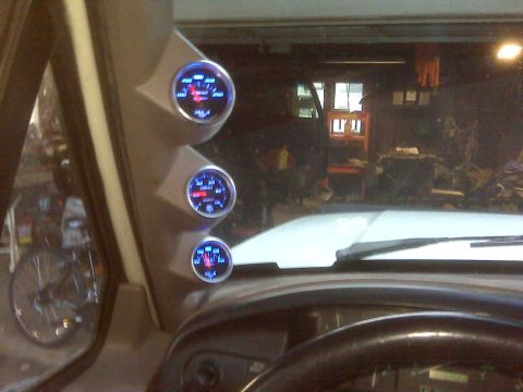 1995 Ford Bronco - A-pillar mounted gauges are visible inside the vehicle's cabin.