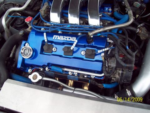 1995 Ford Probe - a pic of the powdercoated candy blue front valve cover and partial pic of the klze show polished intake manifold