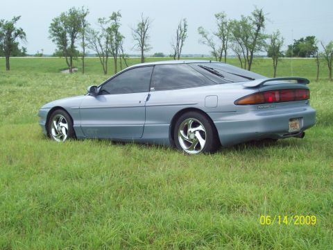 1995 Ford Probe - pic of left side of car with the chrome swirley rims